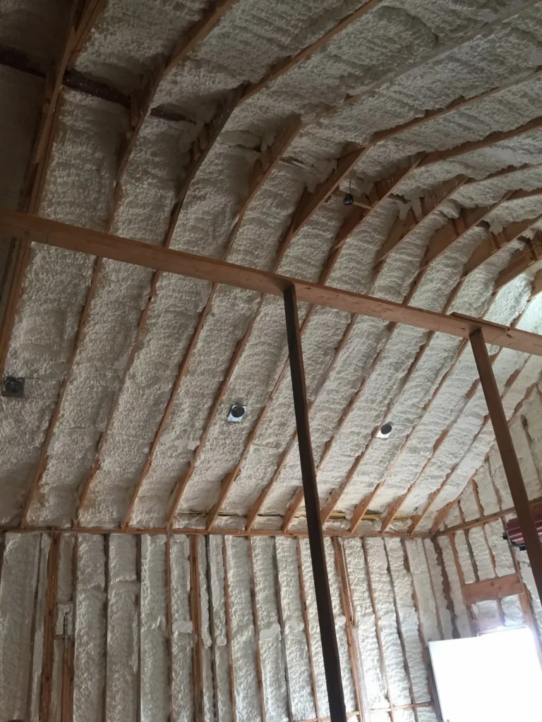 Attic roof deck insulated with spray foam