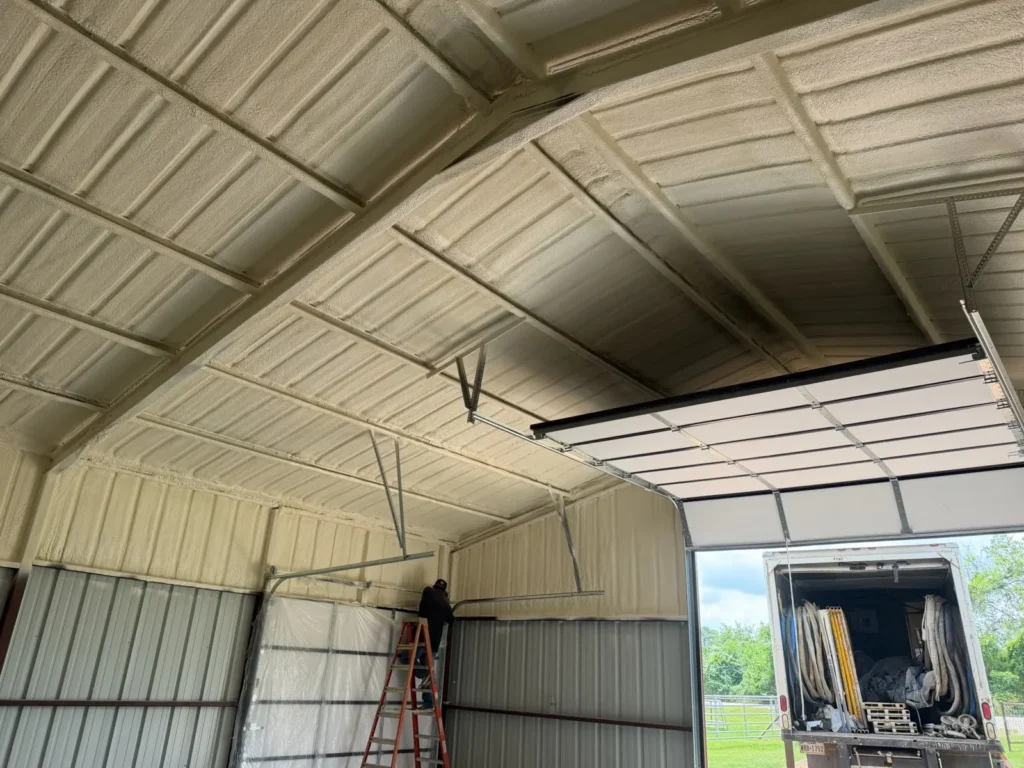 Barn ceiling insulated with spray foam, work truck at the door