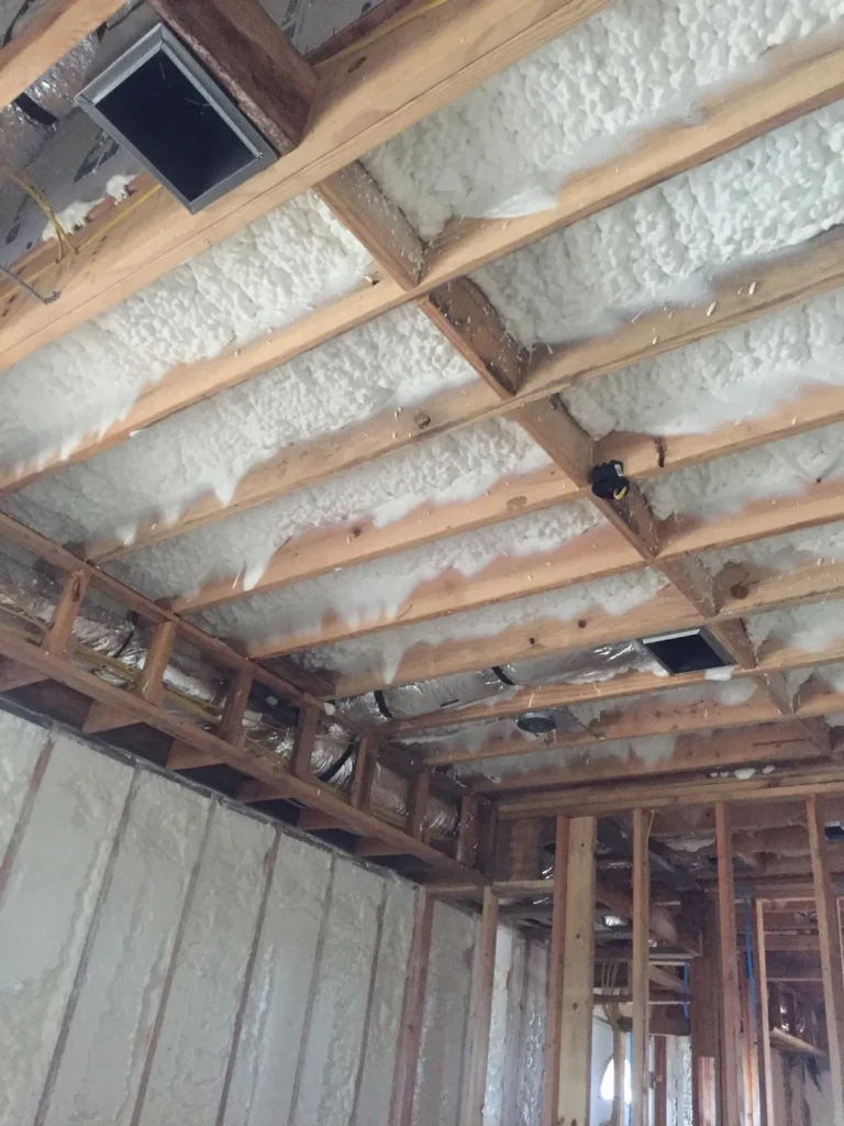 Ceiling joists after old insulation was removed and foamed
