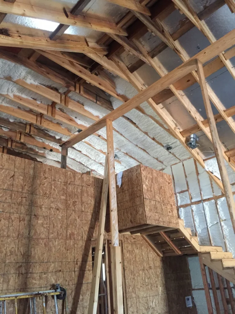 Framed residential attic and walls insulated with open cell foam