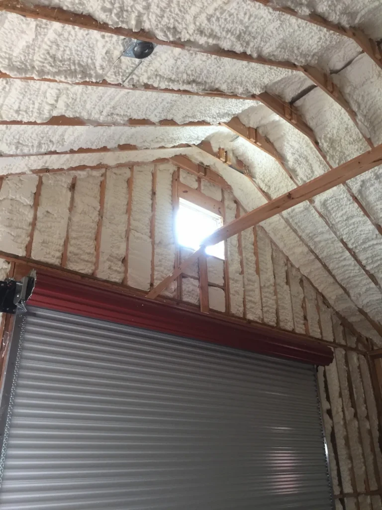 Garage attic above a roll up door insulated with foam