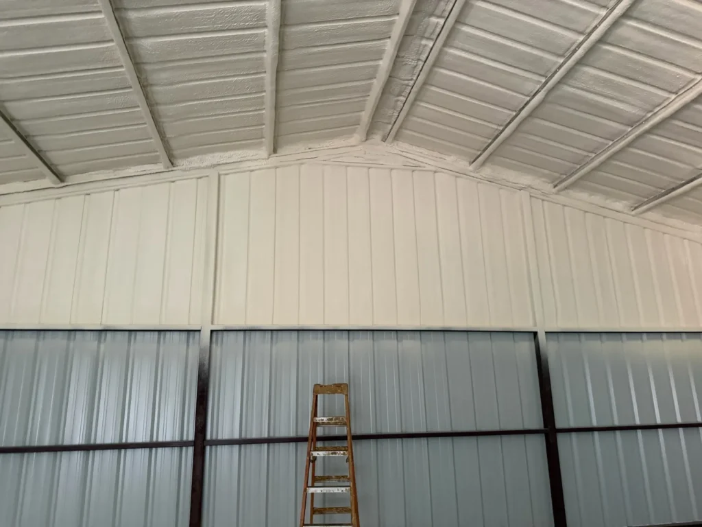 Metal building ceiling and walls coated in spray foam