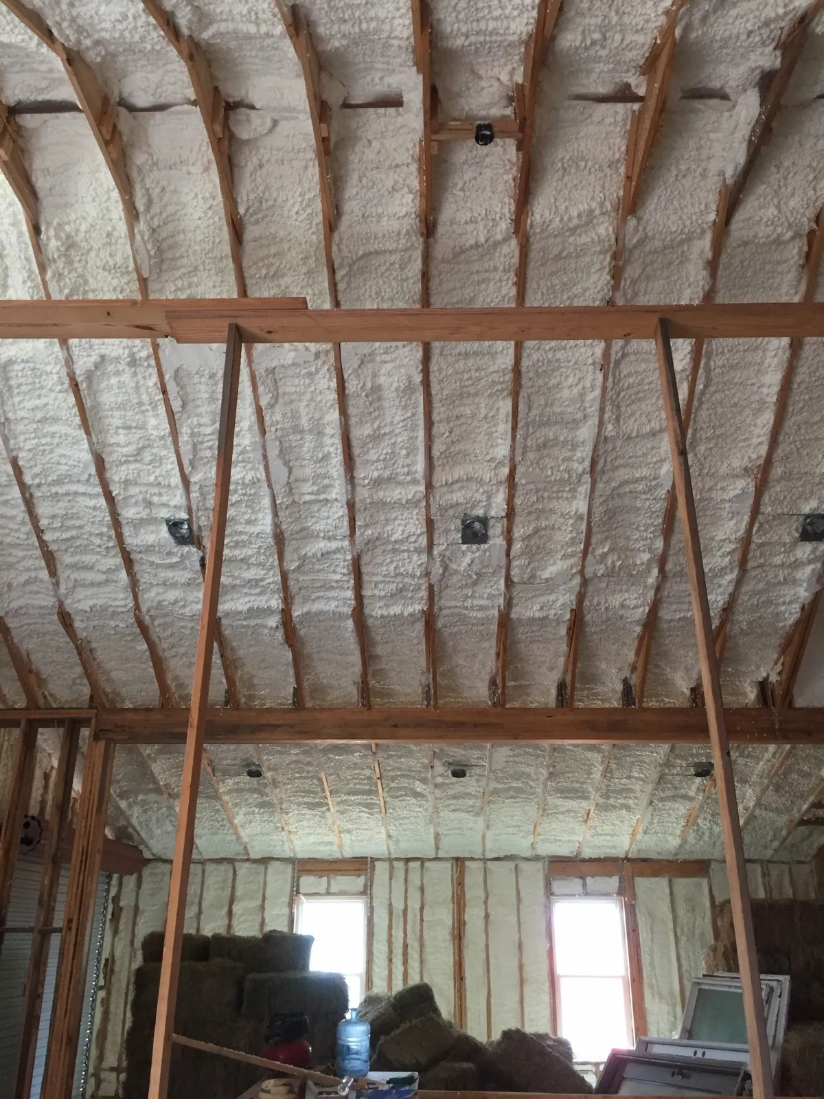 Open cell spray foam between roof rafters